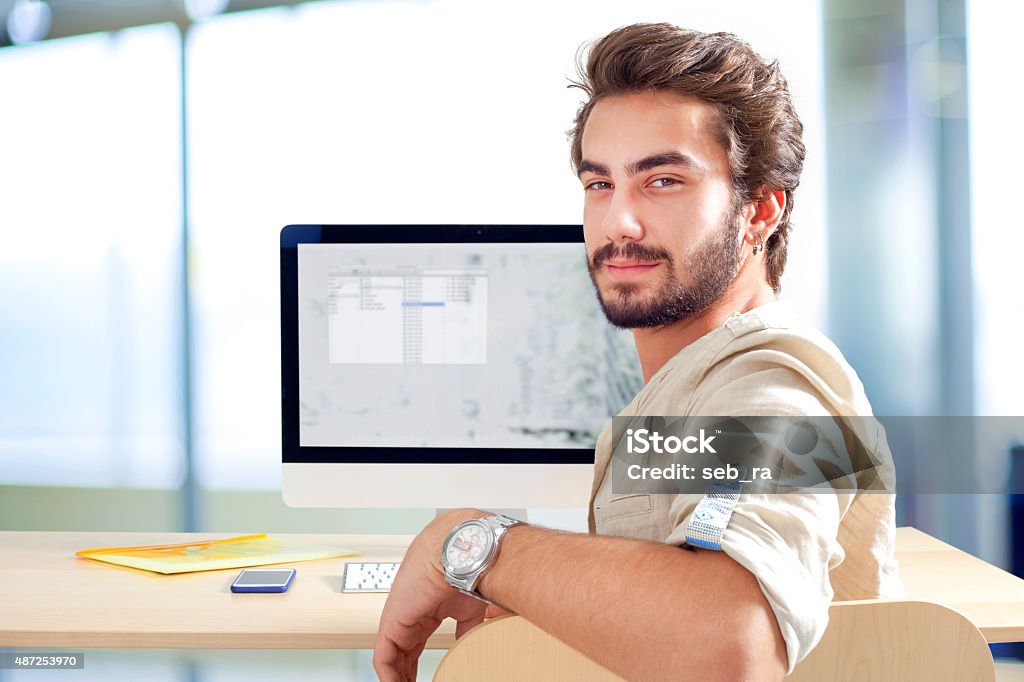 Young man working on computer 2015 Stock Photo