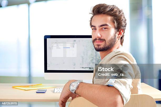 Young Man Working On Computer Stock Photo - Download Image Now - 2015, Adult, Adults Only