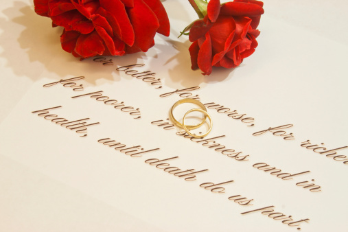 Picture of wedding rings with vows and roses