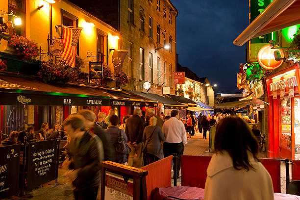 Galway, Ireland - August 27, 2012: Street with pubs in Galway, Ireland. People are walking around.