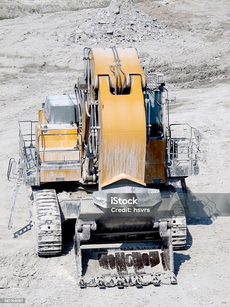 Excavator in surface mine quarry Excavator in a surface mine quarry. mining industry. Arranging Stock Photo