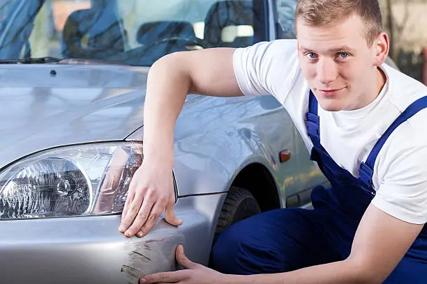 Photo of Mechanic repairing car scratching