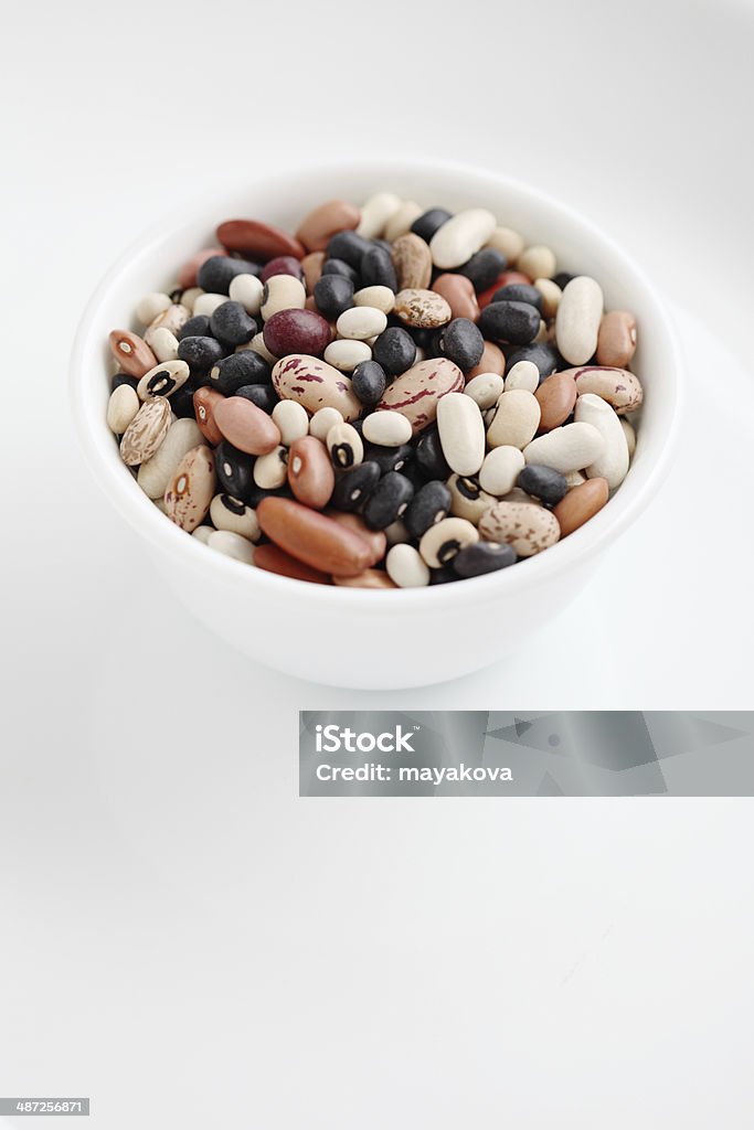 Assorted dried beans in a bowl isolated Assorted dried beans in a bowl isolated on white background Bean Stock Photo