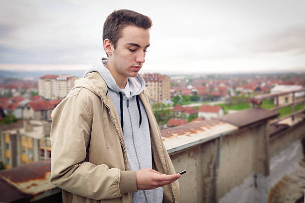 istock Teenage boy with mobile phone 487257201