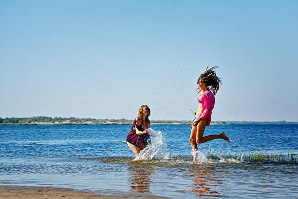 istock Best friends squirting in the river. 487259700