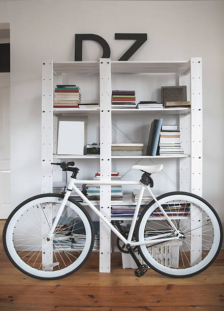 Trendy bicycle in a modern interior. Hipster bike in the interior. Road bike near the bookshelves