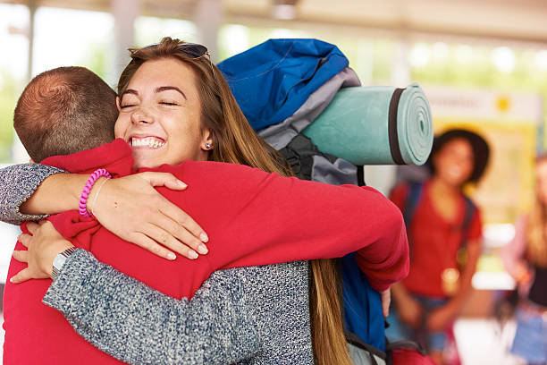 istock Backpacking friends arrive home to loved ones 487259826