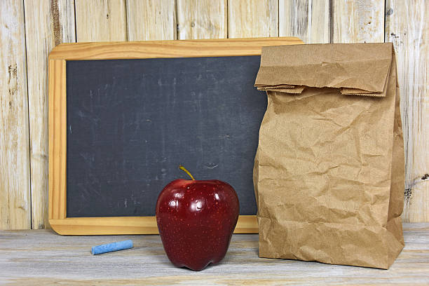 istock brown paper bag with apple 487260130