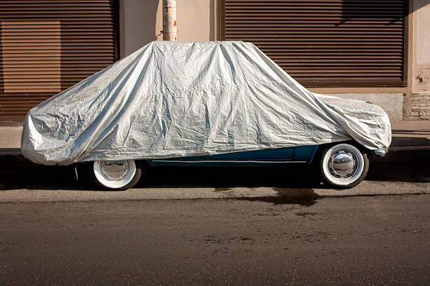 istock Covered vintage car in the street, parked. 487263162