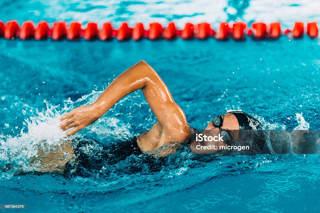 Female Frestyle Swimmer Female freestyle swimming competitor in action Swimming Stock Photo