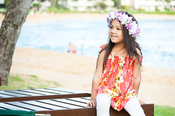 Cute little girl wearing a lei on a Hawaiian beach stock photo