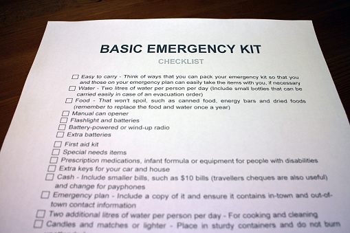 Someone filling out Basic Emergency Kit Checklist.