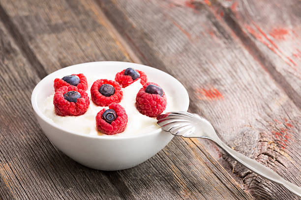 istock Fresh raspberries and blueberries with yogurt 487271913