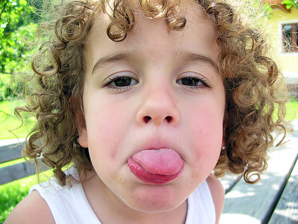 istock Little boy sticking his tongue out 487272235