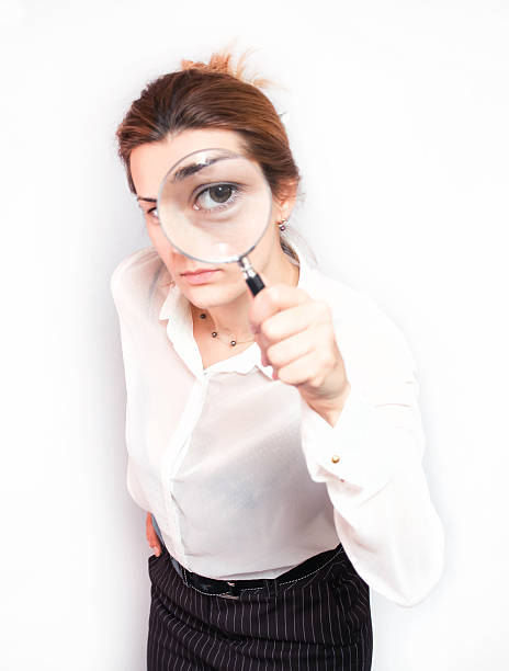 istock Young business woman magnifying 487273679