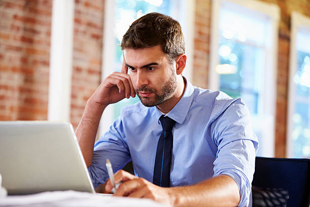 istock Man Working At Laptop In Contemporary Office 487275863