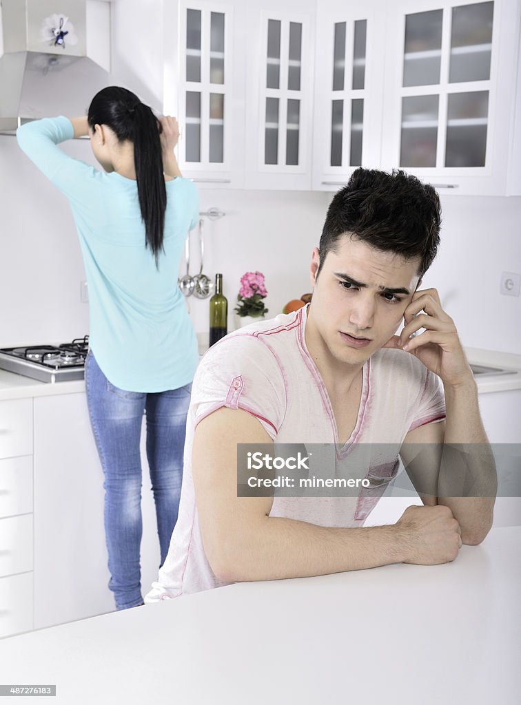 Young couple crisis Young couple having problems and conflict at home in the kitchen. Adult Stock Photo