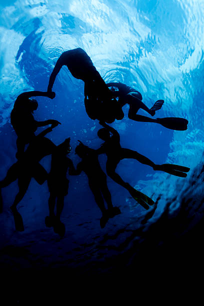 istock People snorkeling and hold together 487276919