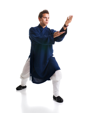 Stock photo of a Kung Fu Master in traditional dress isolated on white background.
