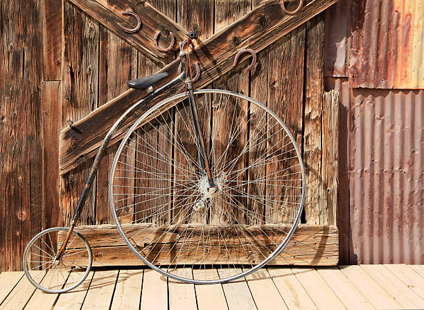istock Old High Wheel Bicycle in Front of Wheathered Barn Door 487294422