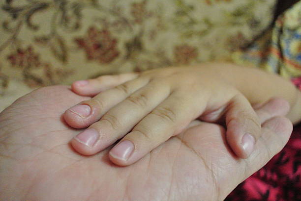 istock my hand holding my daughter's hand 487294770