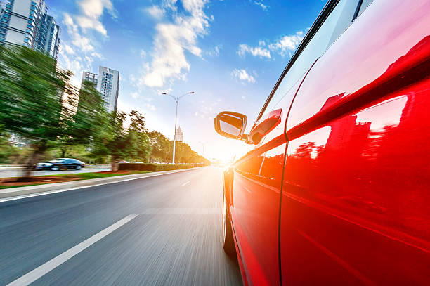 istock car driving on a motorway at high speeds 487294803