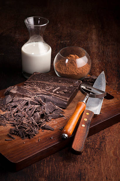 istock Chocolate bars and ingredients on a wooden table 487297185