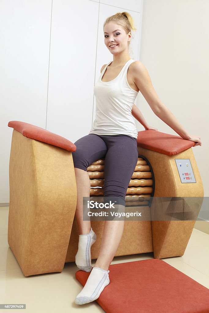 Garota em sportwear em equipamentos de massagem de relaxamento saudável spa e salão de beleza - Foto de stock de Aconchegante royalty-free