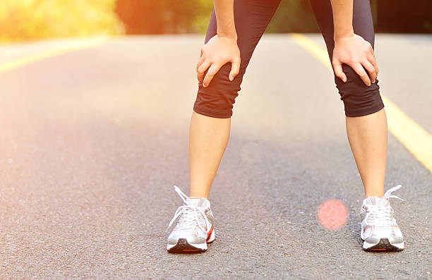 istock tired woman runner  have a rest after running hard 487298089