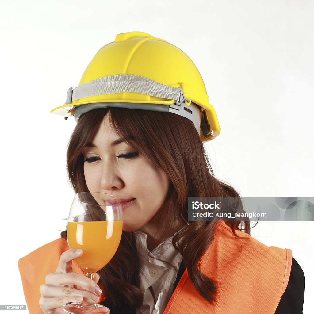 Ingegnere donna con succo d'arancia - Foto stock royalty-free di Adulto