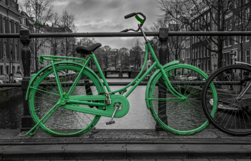 Green bike isolated on black and white over an Amsterdam.