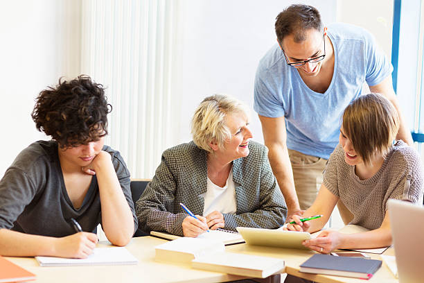 istock students and teacher  in classroom working with digital tablet 487299835