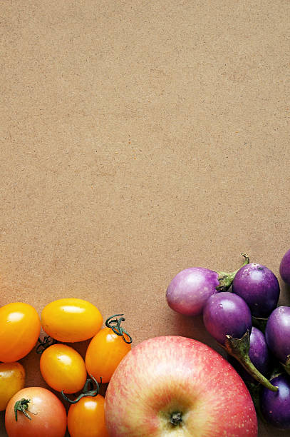 cherry tomatoes and apple on wooden background