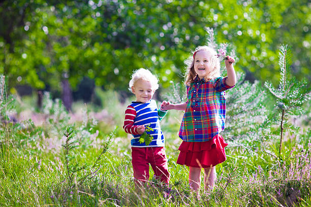 istock Funny kids playing in autumn park 487300230