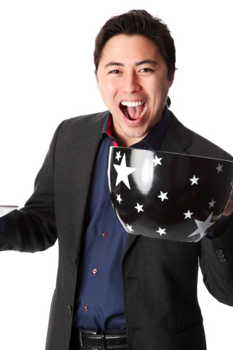 Good looking businessman holding an oversized coffee cup, wearing a suit and tie. White background.