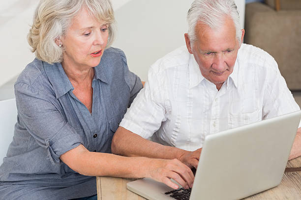 istock Concentrated senior couple using laptop 487301555