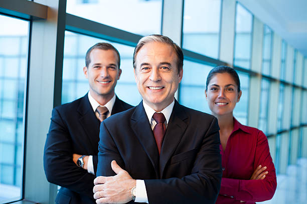 istock Cheerful business team of three posing in hallway 487301727
