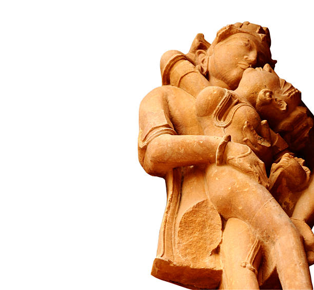 Ancient sculpture of a beautiful couple with white background Ancient sculpture of a beautiful couple in intimate position with white background. Sculpture has been cut out from one of the sculptures at Khajuraho, a UNESCO heritage site. No release is required for this sculpture. loving couple sculpture in khajuraho stock pictures, royalty-free photos & images