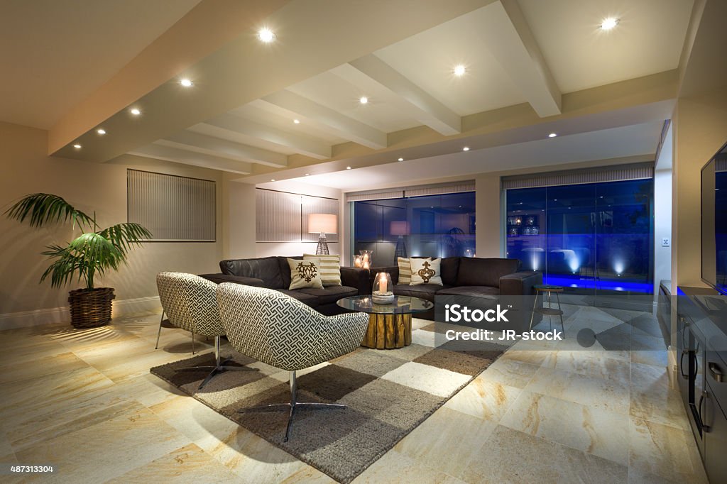 Luxurious living room Luxurious living room  with big windows, couple of sofas and armchairs Illuminated Stock Photo