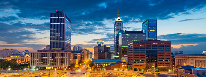 Image of Indianapolis skyline at sunset. This is composite of five vertical images stitched together in photoshop.