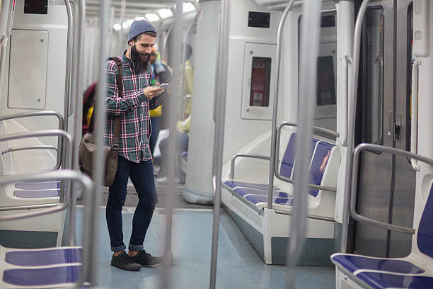 istock Man listening to music on underground 487313480