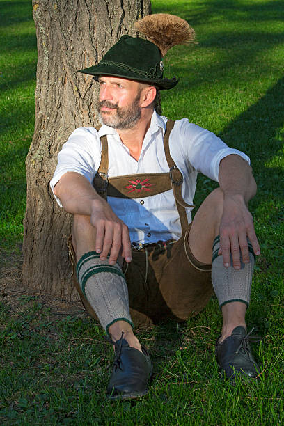 istock man in traditional bavarian clothes sitting by a tree 487316942