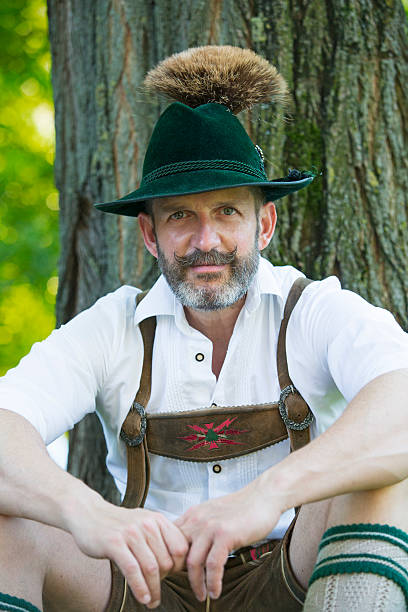 istock man in traditional bavarian clothes sitting by a tree 487317068