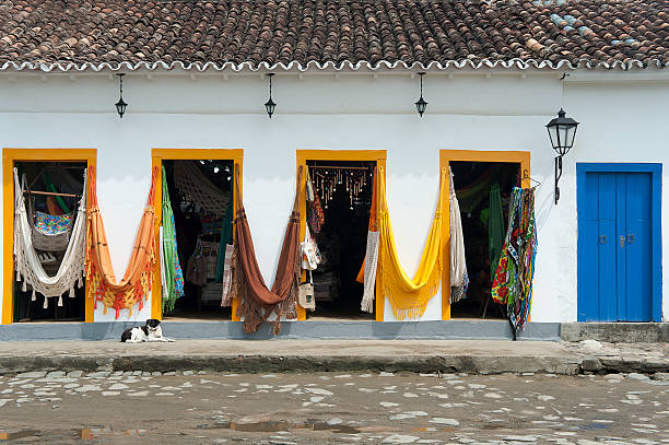 Facade of typical colorful house with cobbled street and vintage camera in Paraty, Rio de Janeiro, Brazil.  The preserved colonial center of the city was included on UNESCO World Heritage list in 2019.