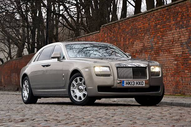 Rolls-Royce Silver Ghost Extended on the street Warsaw, Poland - March, 6th, 2014: Test drive of a extremely luxurious limousine Rolls-Royce Silver Ghost in long version - Extended. This car is one of the few new cars with second row doors opening opposite to the driving direction. The Silver Ghost debut in 2009 on the market. About 20 percent of parts in this limousine comes from BMW 7-series. The Rolls-Royce is powered by V12, 6,6-litre petrol engine (pushing out 570 HP/780 Nm). rolls royce stock pictures, royalty-free photos & images