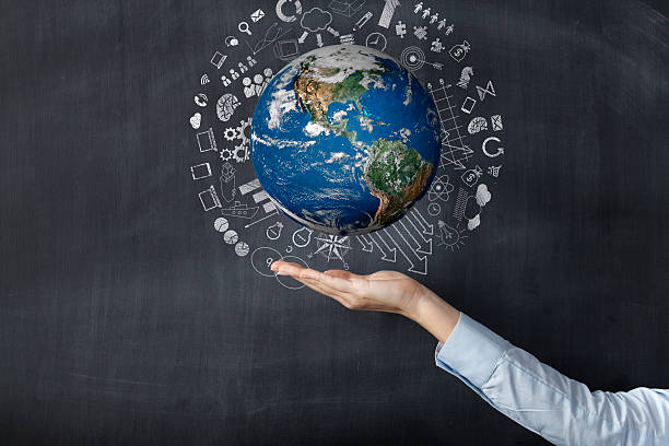 istock Woman holding earth front of blackboard 487324538
