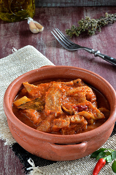 Tripe with tomato sause, spicy chili. Close-up. stock photo