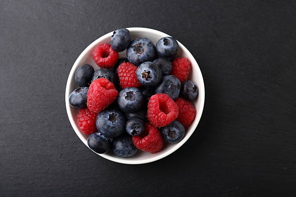 istock Fresh raspberries and blueberries in a plate 487327074