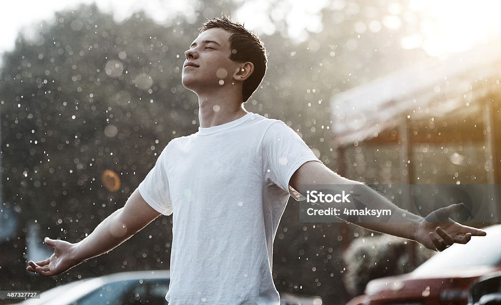 rain and a teenager teenage boy under rain in the city Rain Stock Photo