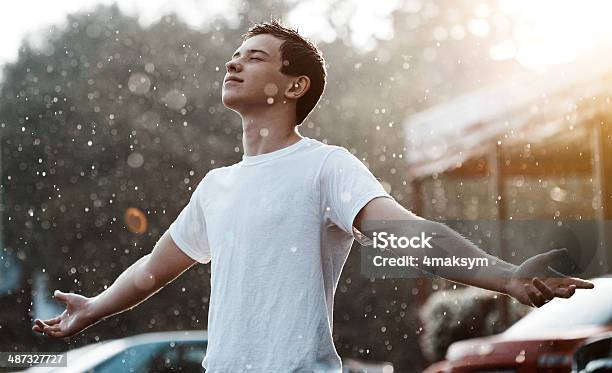 Rain And A Teenager Stock Photo - Download Image Now - Rain, Running, Activity